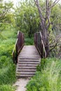small iron bridge with old iron wheel in the countryside Royalty Free Stock Photo