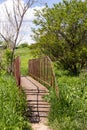 small iron bridge with old iron wheel in the countryside Royalty Free Stock Photo