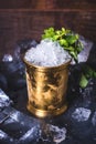 A small iron bucket stands on a table with ice. Royalty Free Stock Photo