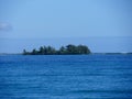 Small island by the blue waters of the Caribbean sea in Placencia, Belize Royalty Free Stock Photo