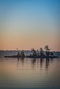 Small island and calm water at sunrise Royalty Free Stock Photo