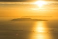 Small island and lonely sailing boat on the ocean during dramatic golden sunset near the coast of Trapani, on Sicily, Italy Royalty Free Stock Photo