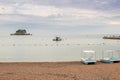 A small island with pine trees and rustic church in adriatic coastline under clouds on blue sky. Fishing boat on calm sea water. Royalty Free Stock Photo