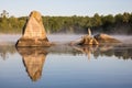 Unique Boulders Reflected In The Calm Early Morning Water