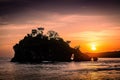 Small island in the sea during sunset. Sunset over the ocean on a tropical island. Nusa Penida, Crystal bay beach, Bali Royalty Free Stock Photo