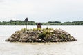 Small island of stones with flying and nesting gulls on the Danube river