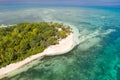 A small island surrounded by azure water and coral reefs, a top view. Royalty Free Stock Photo