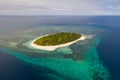 A small island surrounded by azure water and coral reefs, a top view Royalty Free Stock Photo