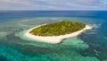 A small island surrounded by azure water and coral reefs, a top view Royalty Free Stock Photo