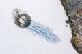 Small island with trees and their shadows on frozen lake ice. aerial view from drone Royalty Free Stock Photo