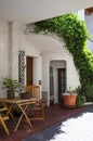 Small Italian courtyard, terrace, shady resting place, green plants Royalty Free Stock Photo