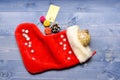 Small items stocking stuffers or fillers little christmas gifts. Christmas sock toned wood background top view. Fill