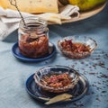 Small jam dishes with rose petal jam, pears and a big piece of cheese on a turquoise table-cloth. Royalty Free Stock Photo