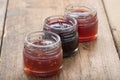 Small jam jar on wood table. Royalty Free Stock Photo