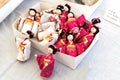 Small Japanese dolls in traditional Japanese clothes in a box.