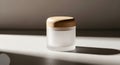 A small jar of foundation makeup sits on a white surface Royalty Free Stock Photo