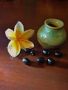 Small jar with frangipani flowers and grains