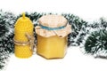 A small jar of honey, a candle made of natural wax on a white background. new year gift