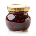 A small jar of strawberry jam with visible fruit chunks, isolated on a Royalty Free Stock Photo