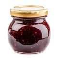A small jar of strawberry jam with visible fruit chunks, isolated on a Royalty Free Stock Photo