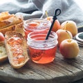 Small jars of crab apple jelly with some spread on toasted sourdough bread. Royalty Free Stock Photo