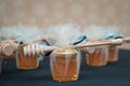 Small jars filled with honey and wrapped in tulle with a honey dipper on it Royalty Free Stock Photo