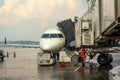 Small jet airplane with attached jetway at airport gate terminal Royalty Free Stock Photo