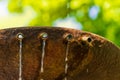 Small jets of water from pipes of a rusty fountain