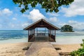 Small jetty or wooden boathouse on tropical sandy beach on La Digue island on Seychelles