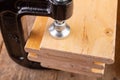 A small joinery clamp used for gluing planks. Accessories for carpenters on the workshop table Royalty Free Stock Photo