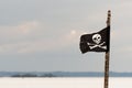 Small jolly roger on a wooden pole Royalty Free Stock Photo