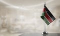 A small Kenya flag on an abstract blurry background