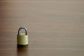 The small key lock on the wooden table background Royalty Free Stock Photo