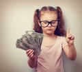 Small kid girl holding dollars and have an plan how earning much Royalty Free Stock Photo