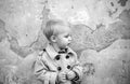 small kid on grunge background. happy childhood. little boy in vintage coat. Beauty. childrens day. retro style. retro