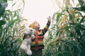 Small kid with his friend toy taddy bear exploring nature together. Cute smiling toddler child walking through autumn cornfield,