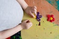 Small kid making a flower by modelling colored clay; overhead view Royalty Free Stock Photo