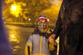 Small kid wearing skull mask, accompanied by an adult