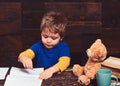 Small kid writing in textbook. Diligent boy learning letters. Early learning concept Royalty Free Stock Photo