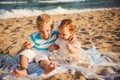 Small kids are playing and having fun at beach together near the ocean, happy lifestyle family concept Royalty Free Stock Photo