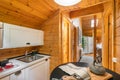 Small kitchen with compact furniture and view to the hallway in wooden house. Village life concept. Royalty Free Stock Photo