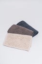 3 small kitchen towels, with recycled material in light brown, dark brown, and dark blue color. On the white background surface Royalty Free Stock Photo