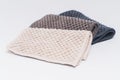 3 small kitchen towels, with recycled material in light brown, dark brown, and dark blue color. On the white background surface Royalty Free Stock Photo