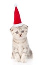 Small kitten in red santa hat looking at camera. isolated on white Royalty Free Stock Photo