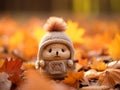 a small knitted bear in a hat sitting in a pile of autumn leaves