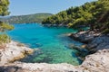 Small lagoon with pine trees and rocks over crystal clear turquoise water near Cape Amarandos at Skopelos island Royalty Free Stock Photo