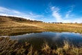 Small Lake for cows with reflections on the Lessinia Plateau Veneto Italy