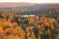 Small lake among hills and trees with fall color in northern Minnesota