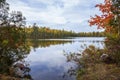 Small lake in northern Minnesota with pines birch and maple trees along the shore during autumn Royalty Free Stock Photo