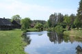 Small lake on the outskirts of the Latvian farm at the end of May 2019 Royalty Free Stock Photo